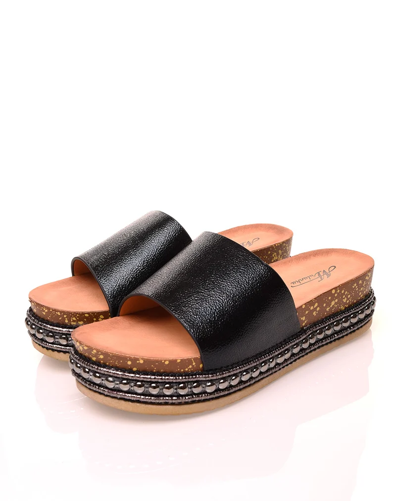 Mules noires brillantes à semelles compensées à détails