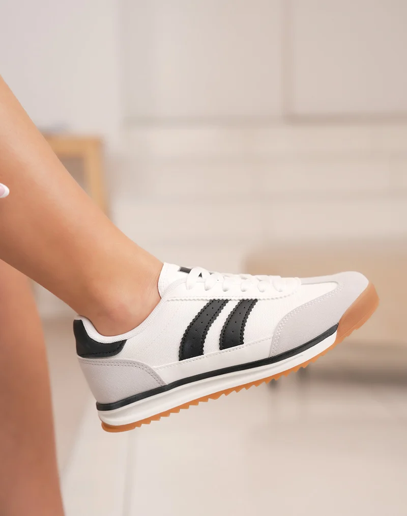 Basket femme blanche tendance avec bandes noires et empiècements contrastés