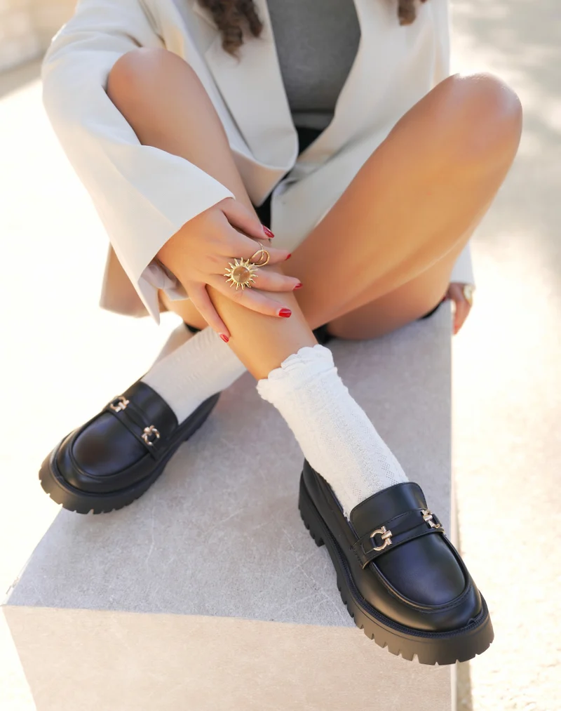 Mocassins femme noirs avec détail doré et semelle crantée épaisse
